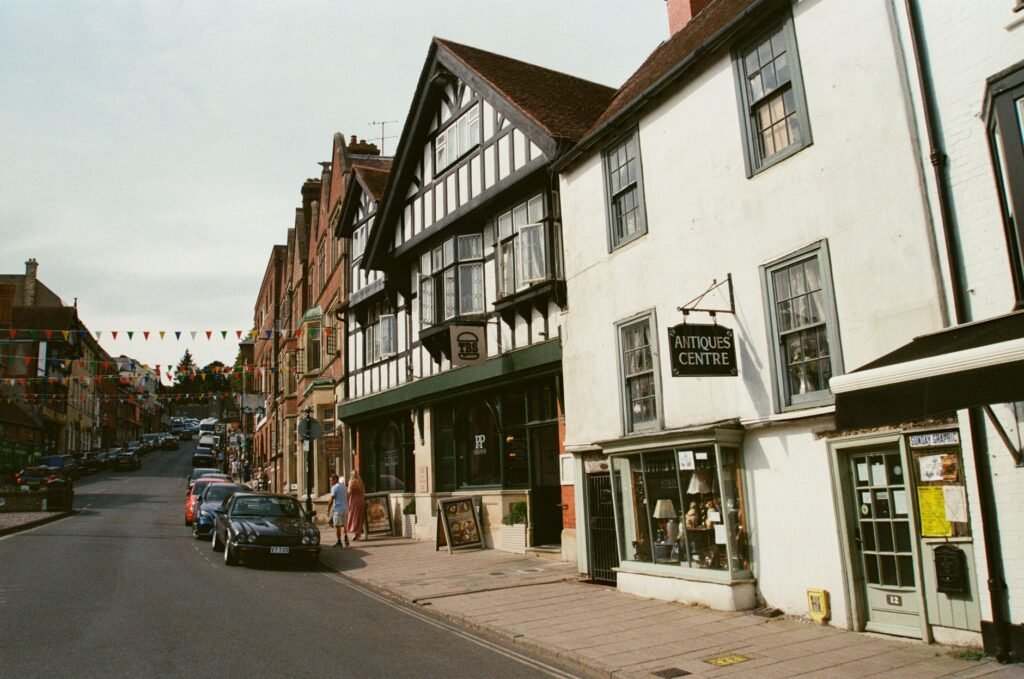 Historic street with storefronts in Arundel, showcasing English architectural style.