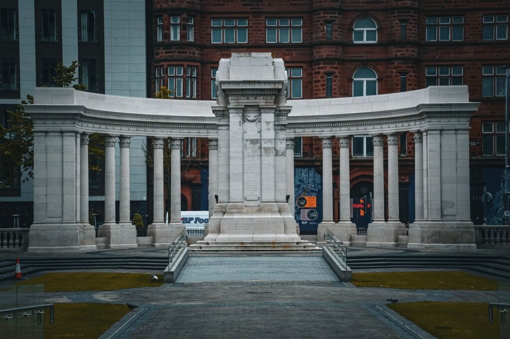 Imposing stone colonnade in a cityscape setting showcasing neoclassical architecture.