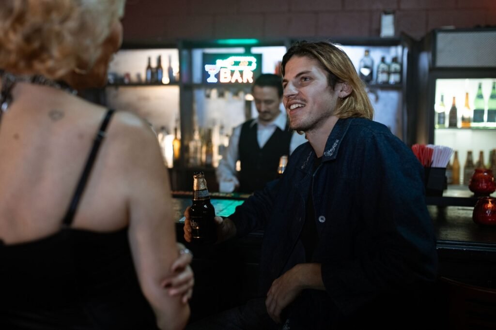 People enjoying a relaxed evening at a local bar with drinks and conversation.