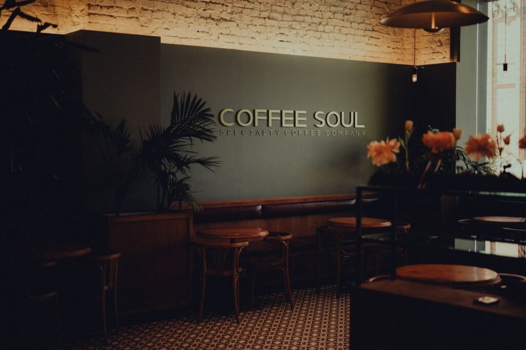 Warm and inviting café interior featuring rustic decor, wooden furniture, and plants.