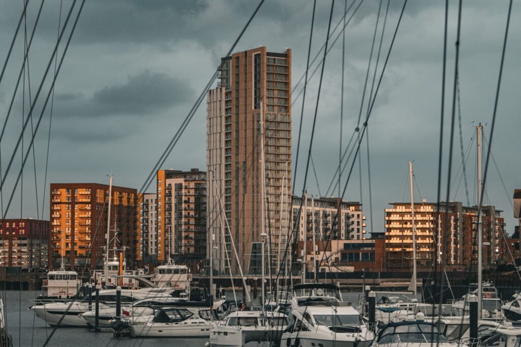 A bustling cityscape with modern buildings and a marina filled with yachts.