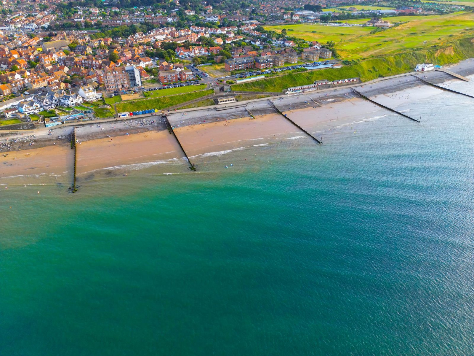 Vibrant aerial shot of Sheringham beach and town on a sunny day in Norfolk, England.