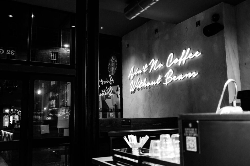 Cozy coffee shop in Edinburgh with neon sign ambiance at night.