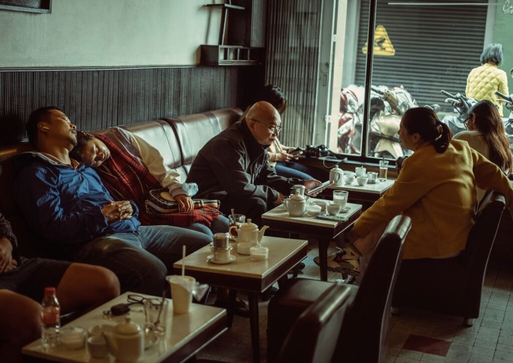A relaxed moment in a cozy urban café with people enjoying coffee and conversation.