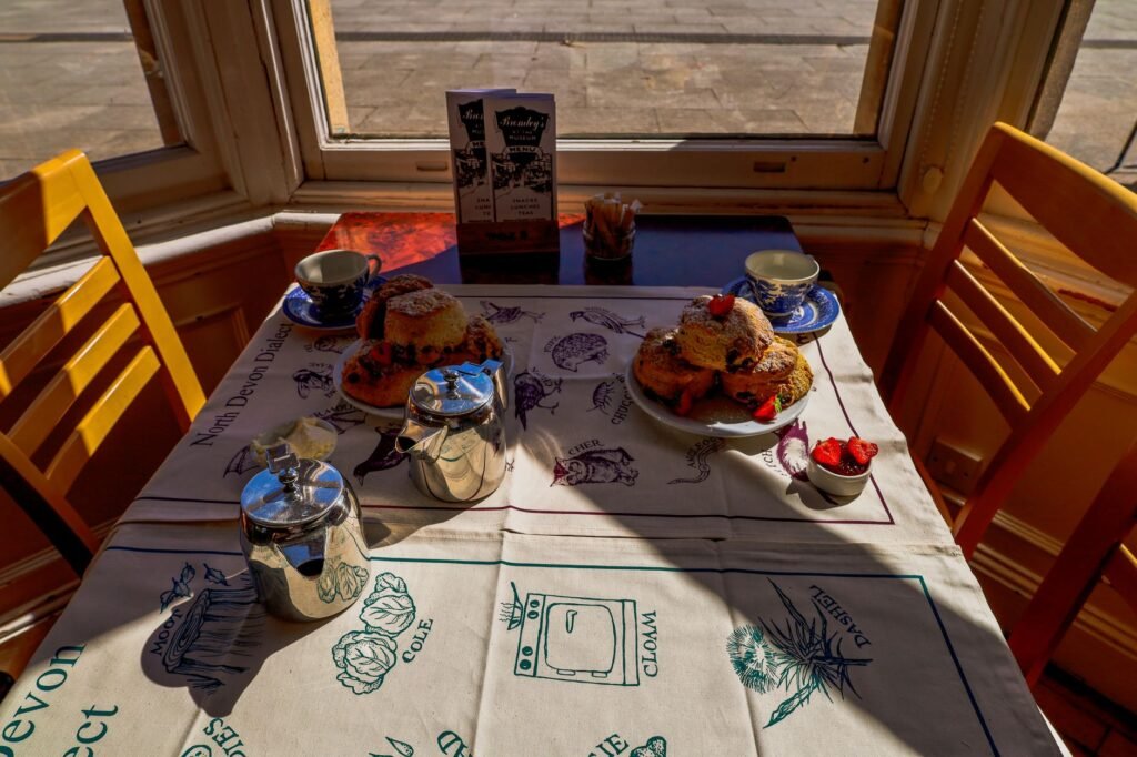 Charming table with scones and tea in an English cafe, perfect for afternoon tea lovers.