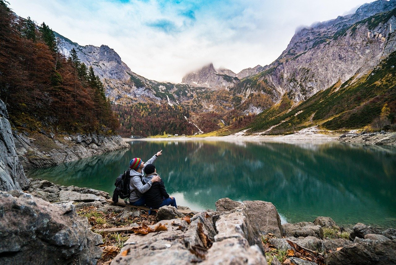 couple, lake, mountains, point, pointing, lovers, together, hikers, mountaineers, sit, sitting, adventure, mountain lake, alp