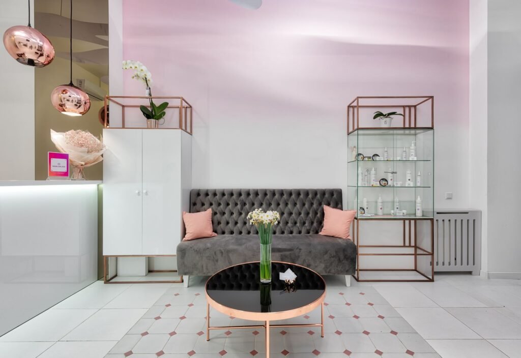 Modern lounge interior with sofa between closet and glass cabinet against table with flowers in vase
