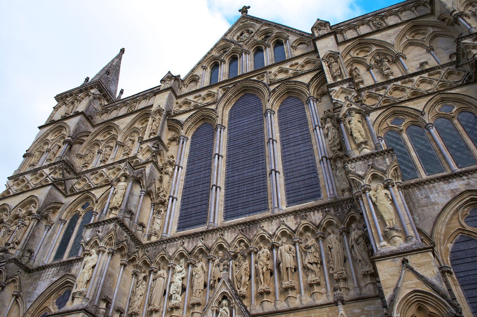 Detailed view of Salisbury Cathedral's intricate Gothic facade in England.
